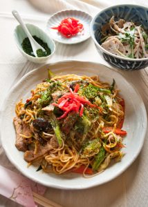 Yakisoba (焼きそば) is the Japanese version of stir fry noodles. Noodles are cooked with sliced pork and plenty of vegetables - cabbage, bean sprouts, carrots, onion and shallots / scallion, then coated with special sauce. Yum!