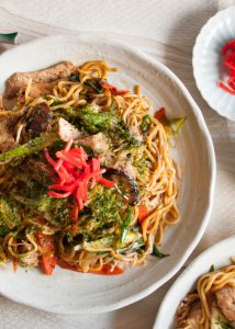 Yakisoba (焼きそば) is the Japanese version of stir fry noodles. Noodles are cooked with sliced pork and plenty of vegetables - cabbage, bean sprouts, carrots, onion and shallots / scallion, then coated with special sauce. Yum!
