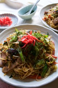 Yakisoba (焼きそば) is the Japanese version of stir fry noodles. Noodles are cooked with sliced pork and plenty of vegetables - cabbage, bean sprouts, carrots, onion and shallots / scallion, then coated with special sauce. Yum!