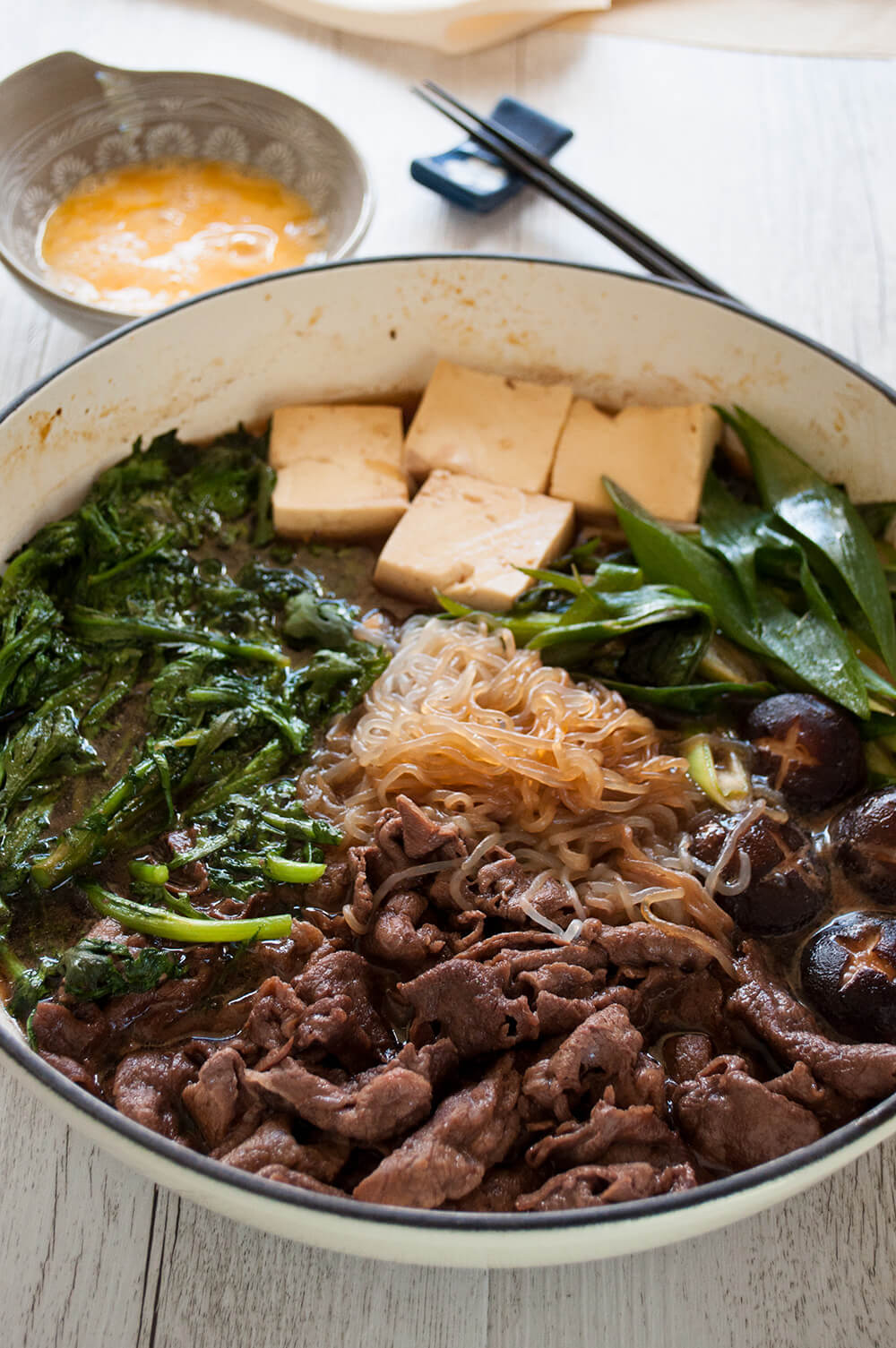 One of the most popular Japanese hot pot dishes, sukiyaki (すき焼き) is great for get-together with friends and family. Cooking thinly sliced beef, tofu and vegetables in sweet soy sauce flavour over a portable cooktop on the table is so much fun. It is quick to prepare and so tasty.