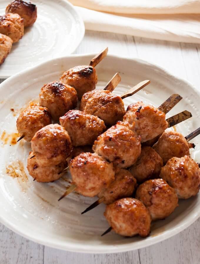 Chicken tsukune (Japanese chicken meatballs) is one of the regular yakitori dish items. Soft and bouncy meatballs are skewered and chargrilled with sweet soy sauce, ie. yakitori sauce. The key to my soft and juicy meatballs is the grated onion and amount of fat in the chicken mince (ground chicken).