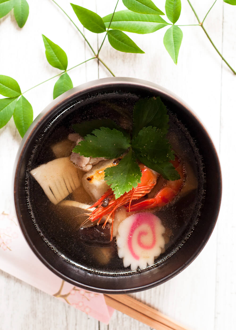 Ozoni is a special dish that most Japanese households serve on New Year’s Day. It is a clear soup with cooked rice cakes and colourful ingredients such as prawns, shiitake, and mitsuba (wild Japanese parsley). Ingredients can vary and you can even make it vegetarian.
