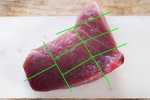 Cutting large block of tuna to sashimi.