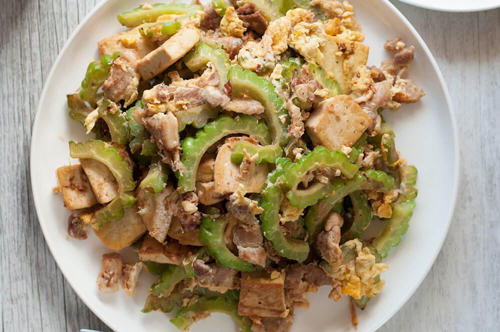 A super easy Japanese stir fry from Okinawa, goya chanpuru is full of bonito flakes, which is unique for a stir fry dish and so flavoursome that you will get addicted to it. It is not greasy at all and my version is made with pork slices instead of SPAM which is the real version of goya chanpuru.