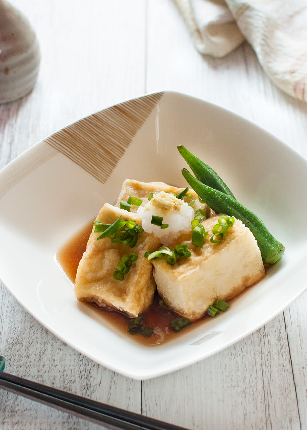 Agedashi Tofu (or Agedashi Dofu) is one of the a-la-carte dishes you always find on the menu at Japanese restaurants. It is delicate and simple but so yummy. The sweet soy sauce-based dashi goes so well with deep fried tofu. 