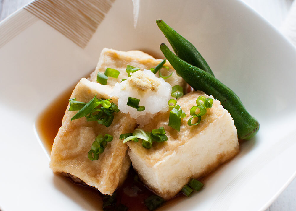Agedashi Tofu (or Agedashi Dofu) is one of the a-la-carte dishes you always find on the menu at Japanese restaurants. It is delicate and simple but so yummy. The sweet soy sauce-based dashi goes so well with deep fried tofu. 