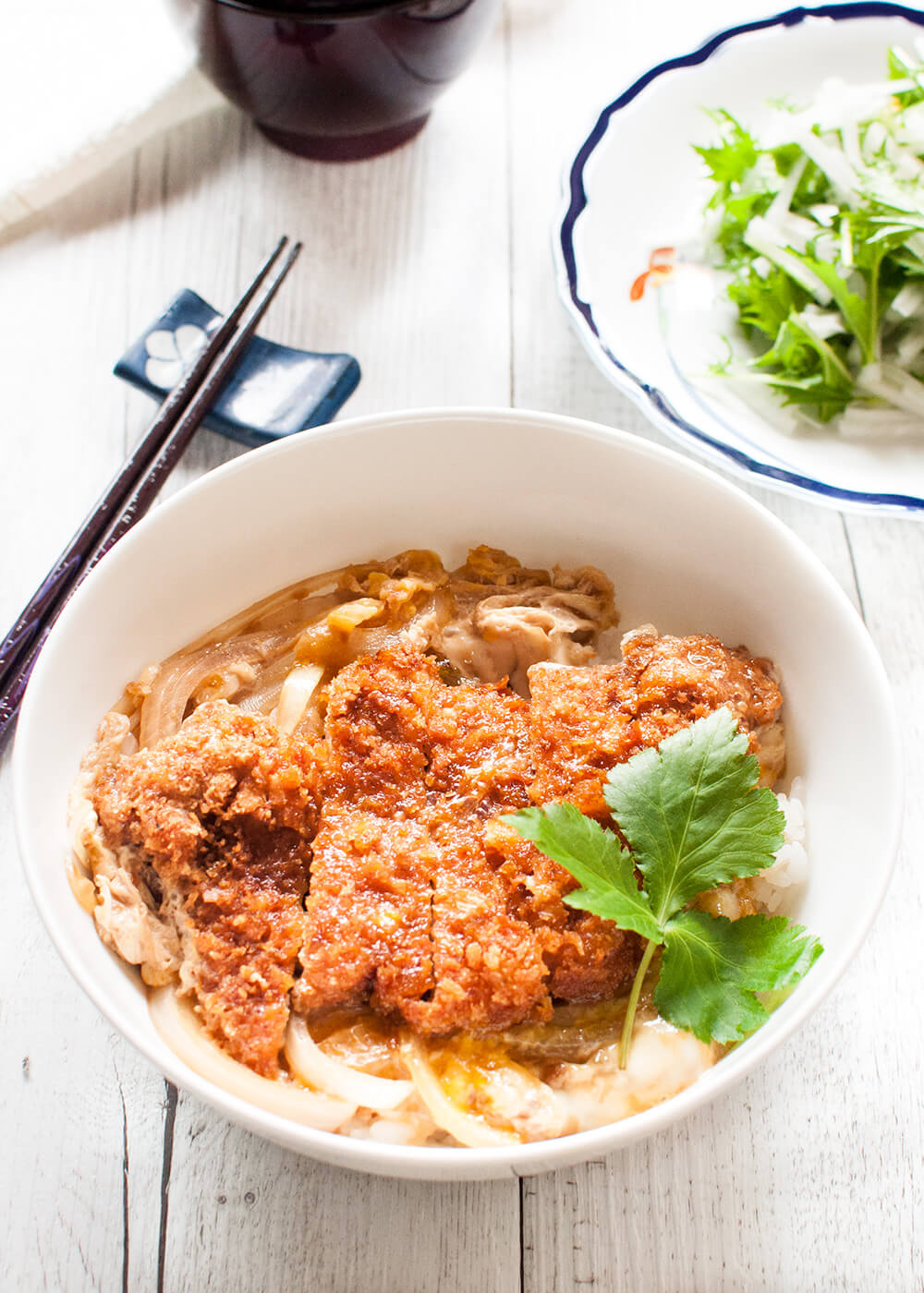Katsu-don (カツ丼), is a very filling main dish. A bowl of rice topped with tonkatsu (deep fried crumbed pork cutlet), onion and beaten egg, cooked in dashi with sweet soy sauce. 
