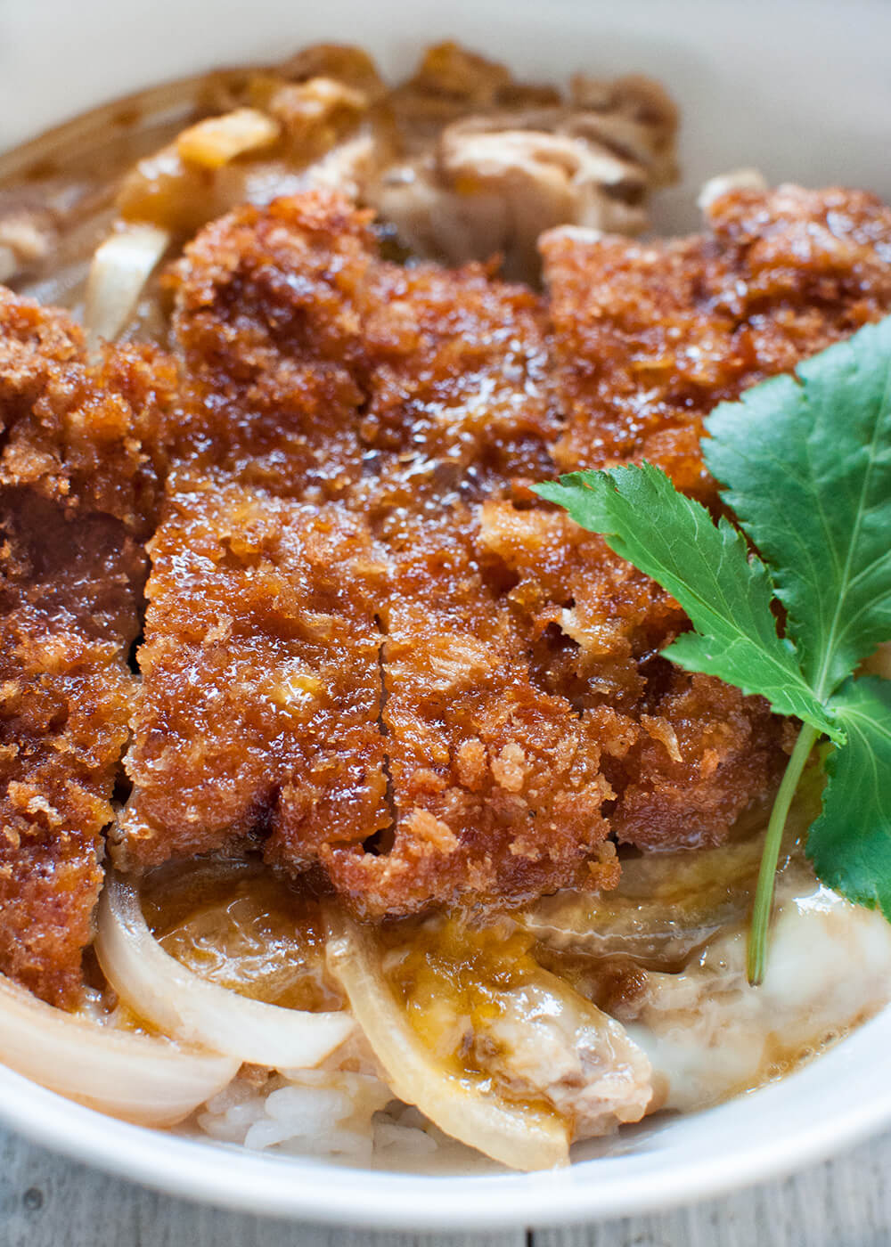 Katsu-don (カツ丼), is a very filling main dish. A bowl of rice topped with tonkatsu (deep fried crumbed pork cutlet), onion and beaten egg, cooked in dashi with sweet soy sauce.