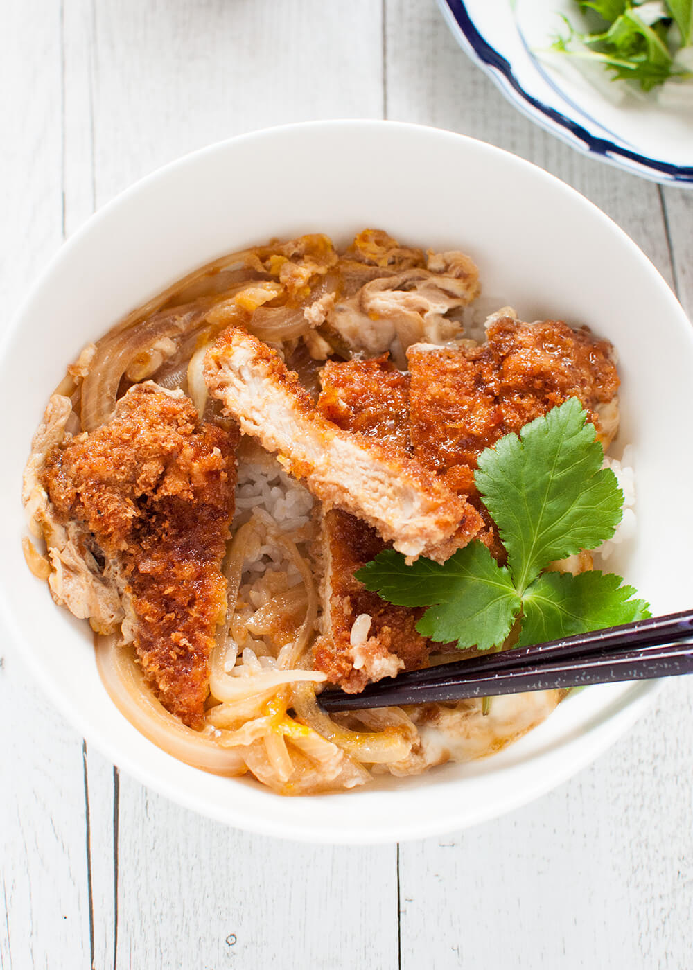 Katsu-don (カツ丼), is a very filling main dish. A bowl of rice topped with tonkatsu (deep fried crumbed pork cutlet), onion and beaten egg, cooked in dashi with sweet soy sauce.