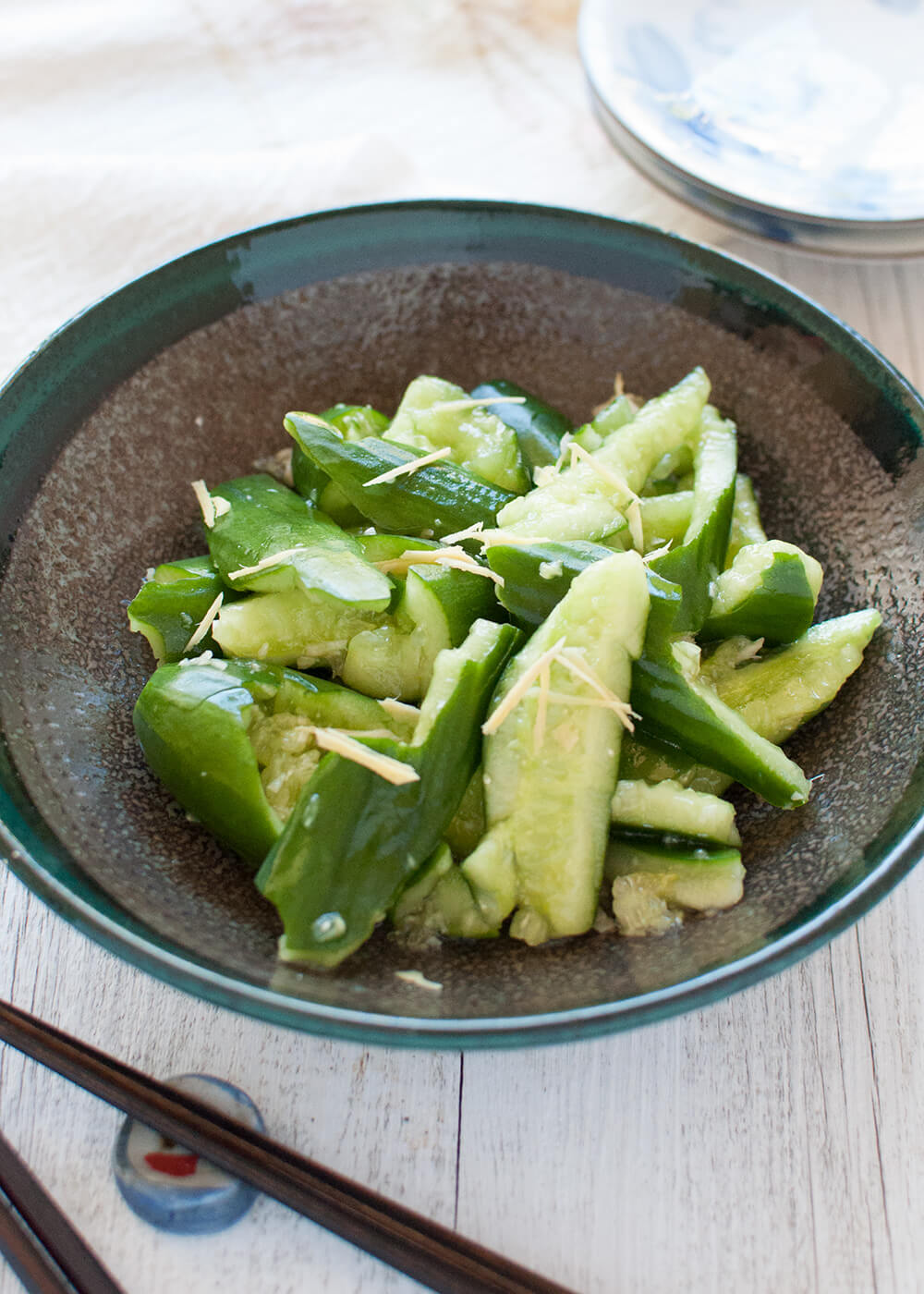 Tataki kyuri is a simple but unique cucumber salad. By smashing the cucumbers, the dressing penetrates into each piece. Ginger and soy sauce in the dressing gives this salad a Japanese touch.