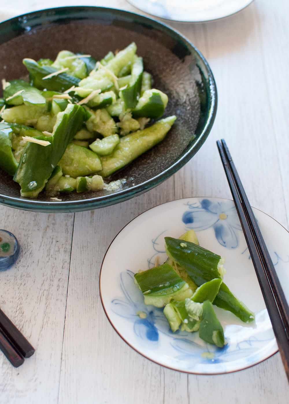 Tataki kyuri is a simple but unique cucumber salad. By smashing the cucumbers, the dressing penetrates into each piece. Ginger and soy sauce in the dressing gives this salad a Japanese touch.