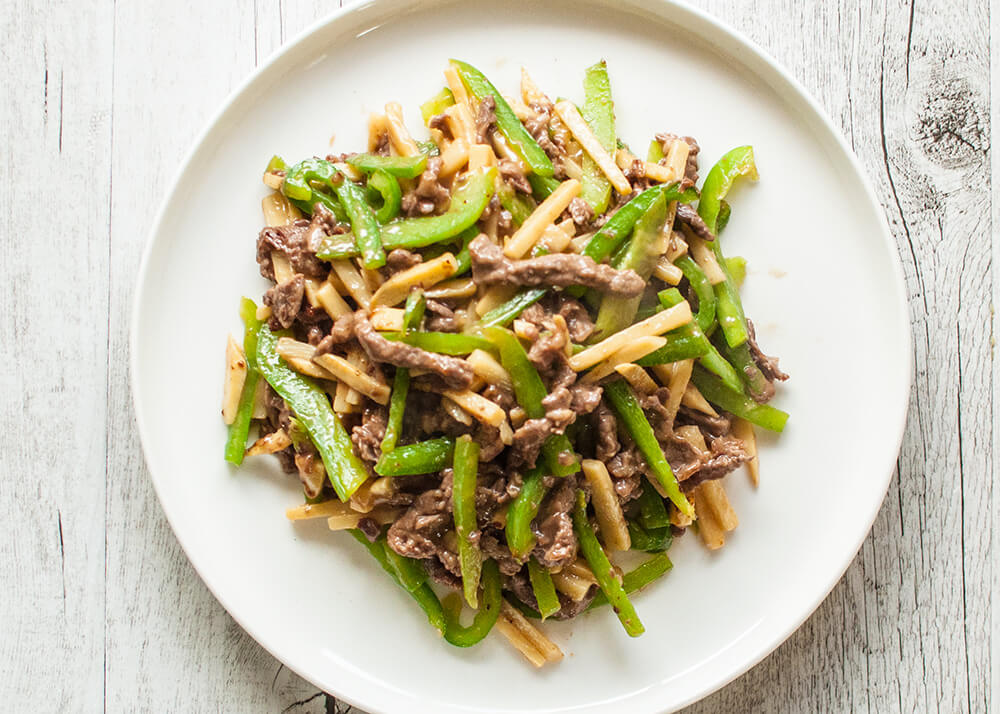This is a quick stir fry dish that originated in China. Beef, green pepper (capsicum) and bamboo shoots are cut into thin strips and cooked in soy flavoured sauce with a touch of oyster sauce.