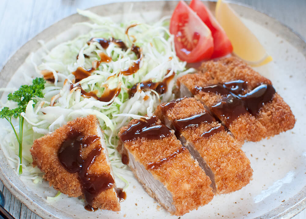 Breaded, deep fried crispy pork cutlet is one of the top 10 favourite dishes among Japanese people. Quite easy to make and served with a sweet fruity sauce, it is so delicious. Tonkatsu is also the main ingredient in Katsudon.