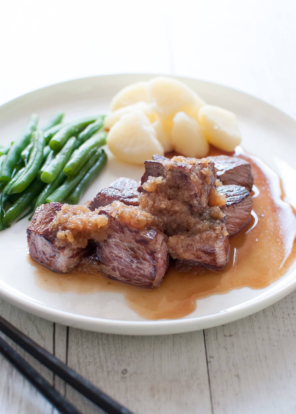 Bite-sized beef steak, Diced Beef Steak is a Japanese invention, easy to pick up with chopsticks. Both sauces are soy-based – one with wasabi flavour, the other one with grated onion, apple and garlic. It is so fast to cook!