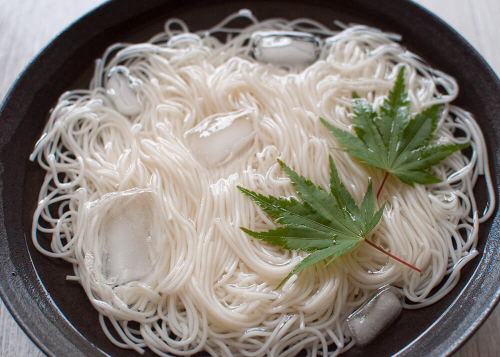 Somen (or sōmen) is a very thin noodles served cold which makes it a perfect summer dish. Noodles are served in chilled water and the dipping sauce is also chilled.