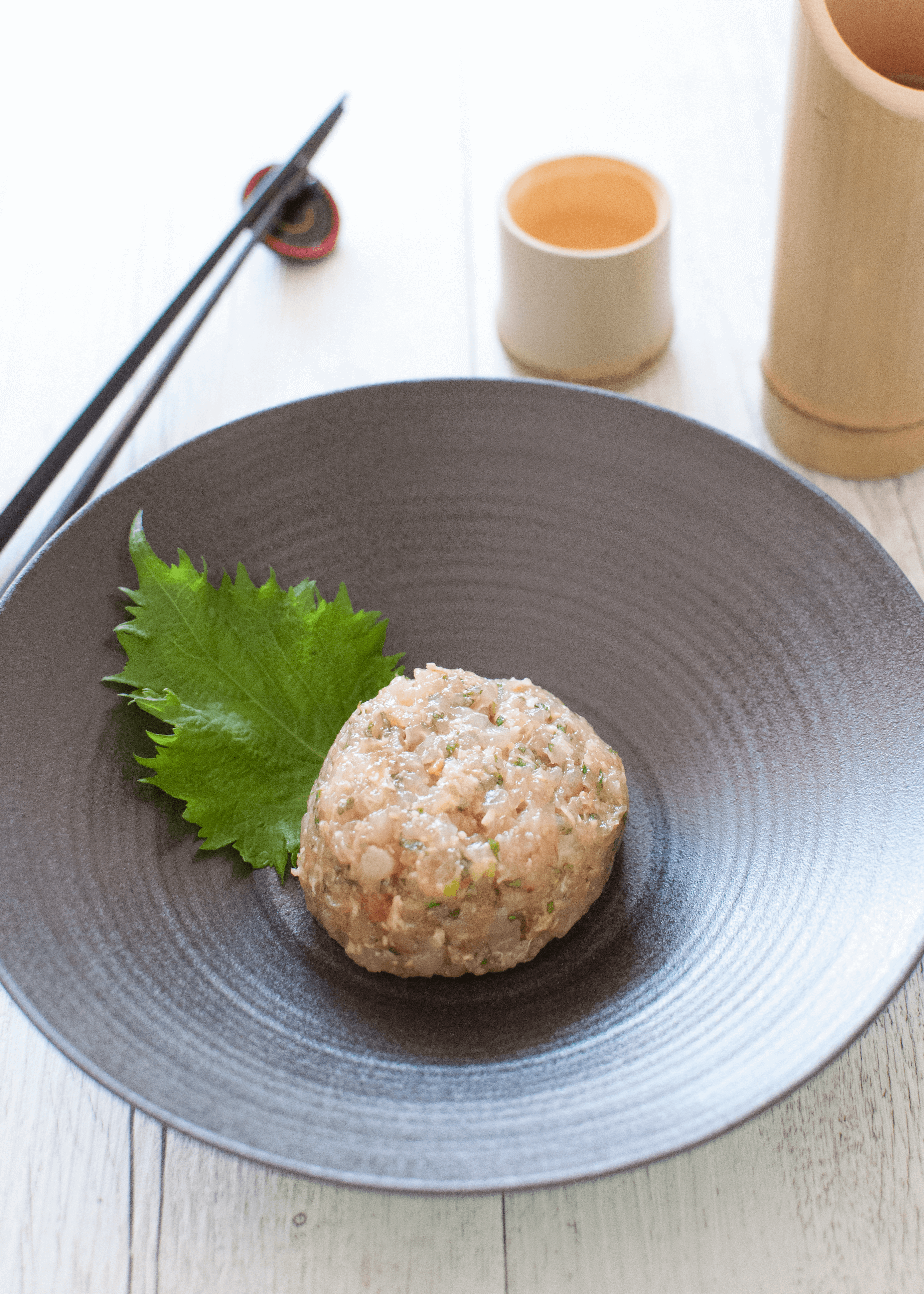 Japanese-style kingfish tartare, called Kingfish Tataki, is a similar dish to fish tartare but with miso flavour. The fish is chopped much more finely than standard fish tartare. Everything is done on a cutting board with a knife, including mixing the ingredients. 