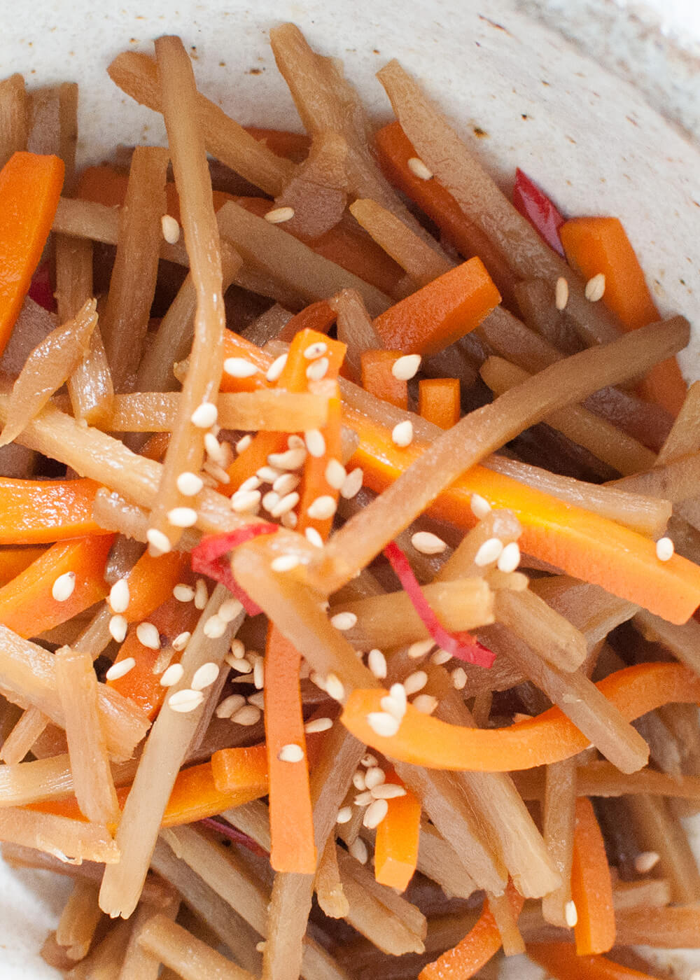 A typical Japanese home cooking dish, Braised Burdock (Kinpira Gobō) is a vegetable side dish. Burdock root and carrot are cut into matchsticks and cooked in a slightly sweet soy sauce. It is very fast to make and can be made ahead of time.