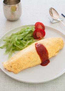 Japanese kids’ favourite dish, omurice (Japanese Rice Omelette) is another Western-influenced Japanese dish. It is basically an omelette with ketchup-flavoured chicken fried rice inside it.