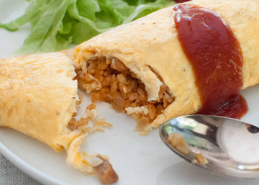 Japanese kids’ favourite dish, omurice (Japanese Rice Omelette) is another Western-influenced Japanese dish. It is basically an omelette with ketchup-flavoured chicken fried rice inside it.