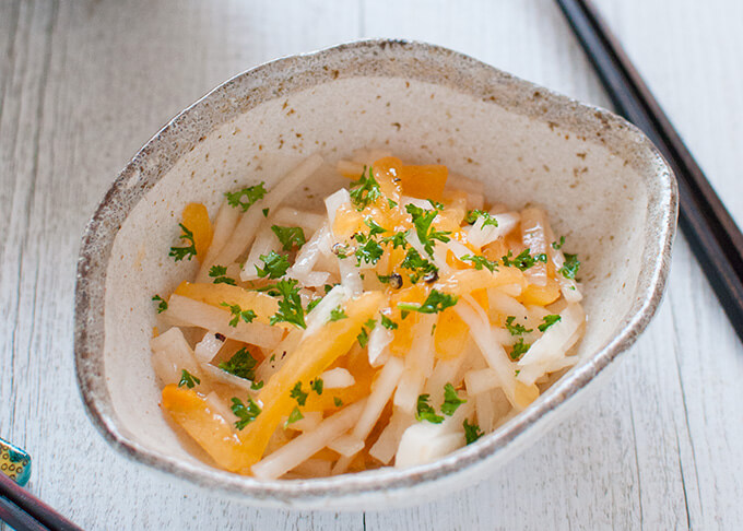 Persimmon and Daikon Salad sprinkled with chopped persely 