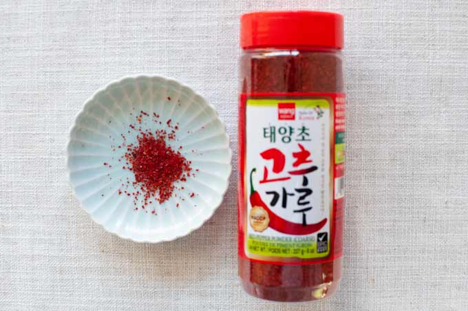 Korean brand corse chilli powder in a plastic bottle.