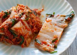 Zoomed in photo of kimchi on a plate.