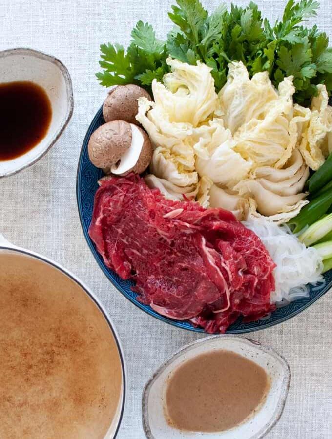 Shabu-shabu served with two dipping sauces.