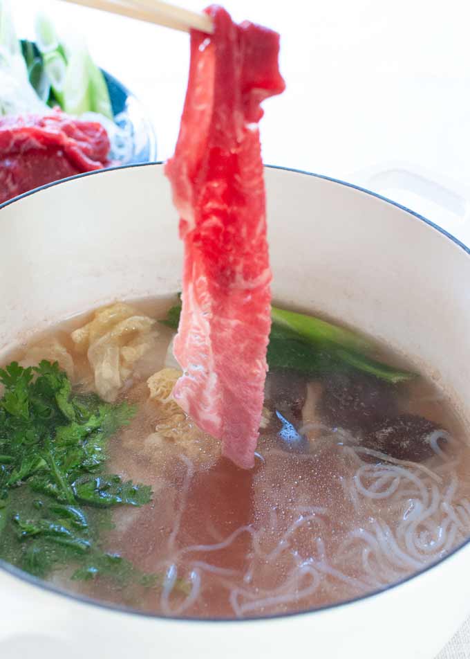 Paper thin beef slice dipped in the konbu broth to cook.