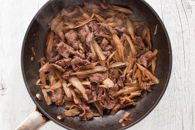 Braised Beef and Burdock with Ginger just cooked in a frying pan.
