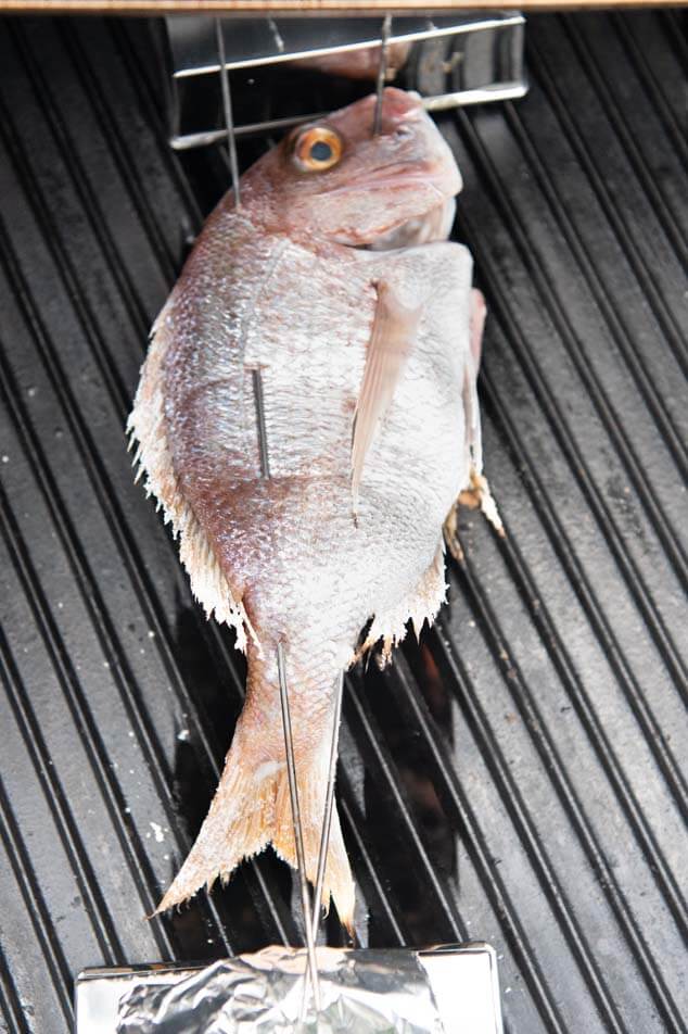 Grilling Whole Snapper on BBQ.
