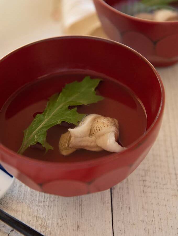 Japanese Clear Soup with Whiting in a red soup bowl.