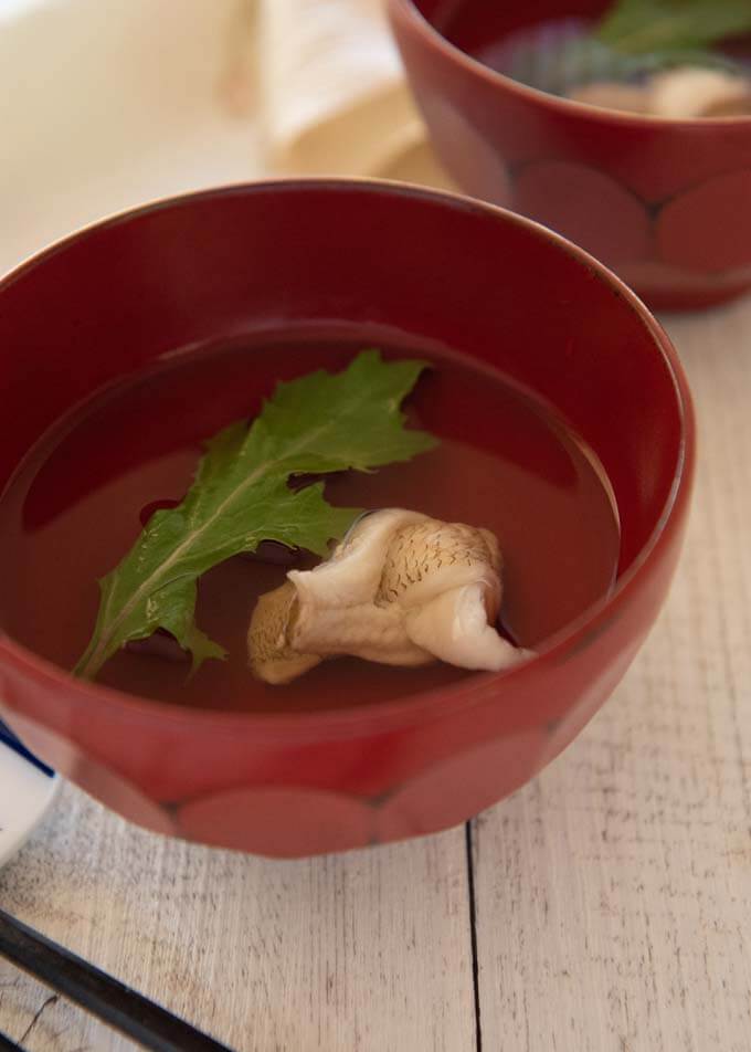 Japanese Clear Soup with Whiting in a red soup bowl.