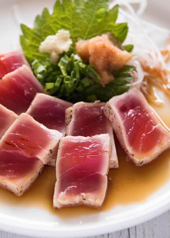 Hero shot of Tuna Tataki with Ponzu Dressing and condiments.