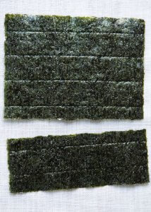 A nori sheet cut to the size for a Take Away Sushi Roll.
