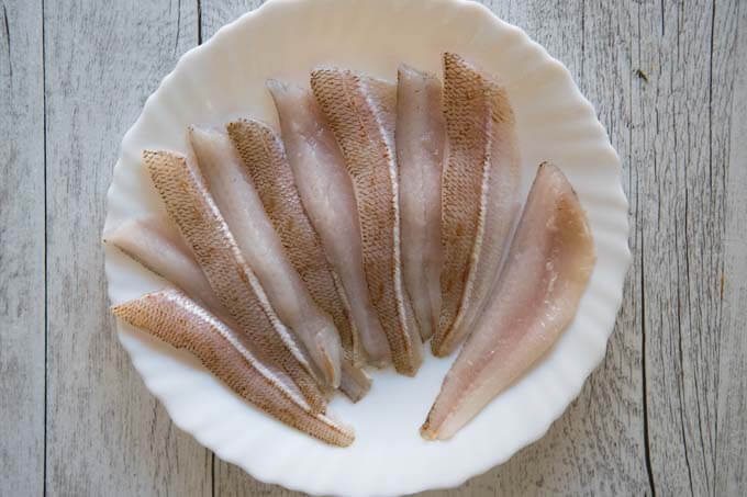 Filleted whiting on a plate.