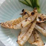 Hero shot of 5 grilled whiting fillets on a plate.