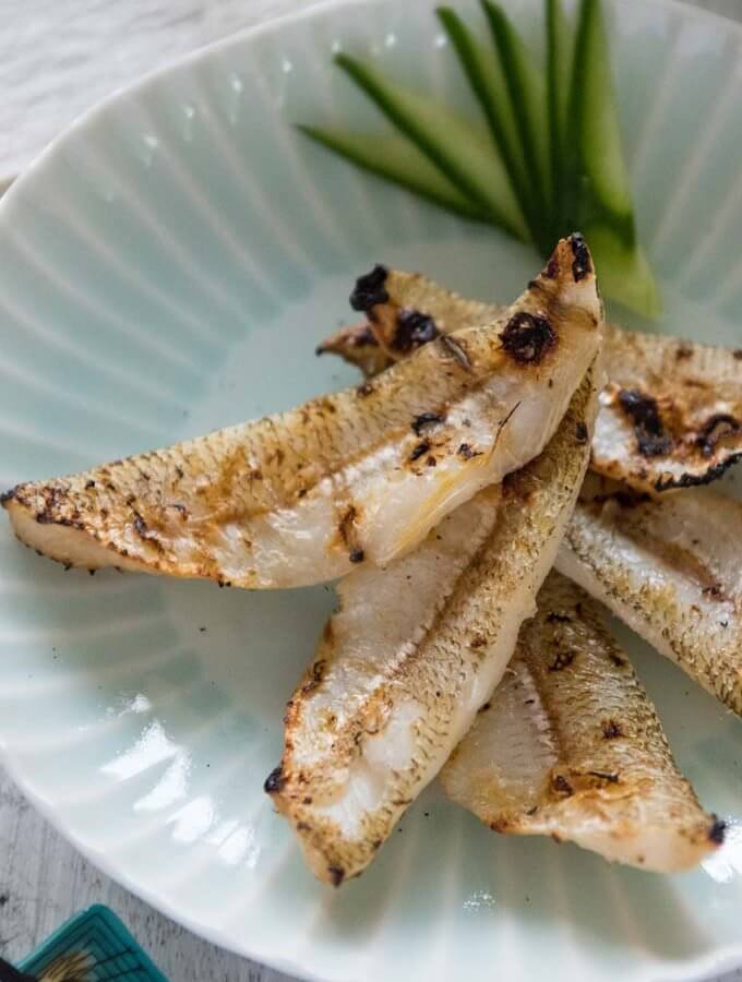 Hero shot of 5 grilled whiting fillets on a plate.