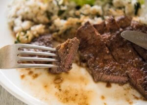 Zoomed-in photo of a pice of the steak with Japanese garlic sauce.