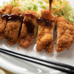 Japanese chicken Cutlet , sauce pouring over it (square photo).