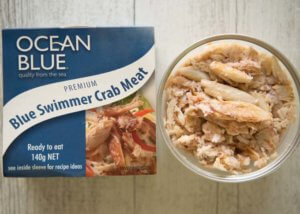 Store-bought cooked blue swimmer crab meat in a tab.