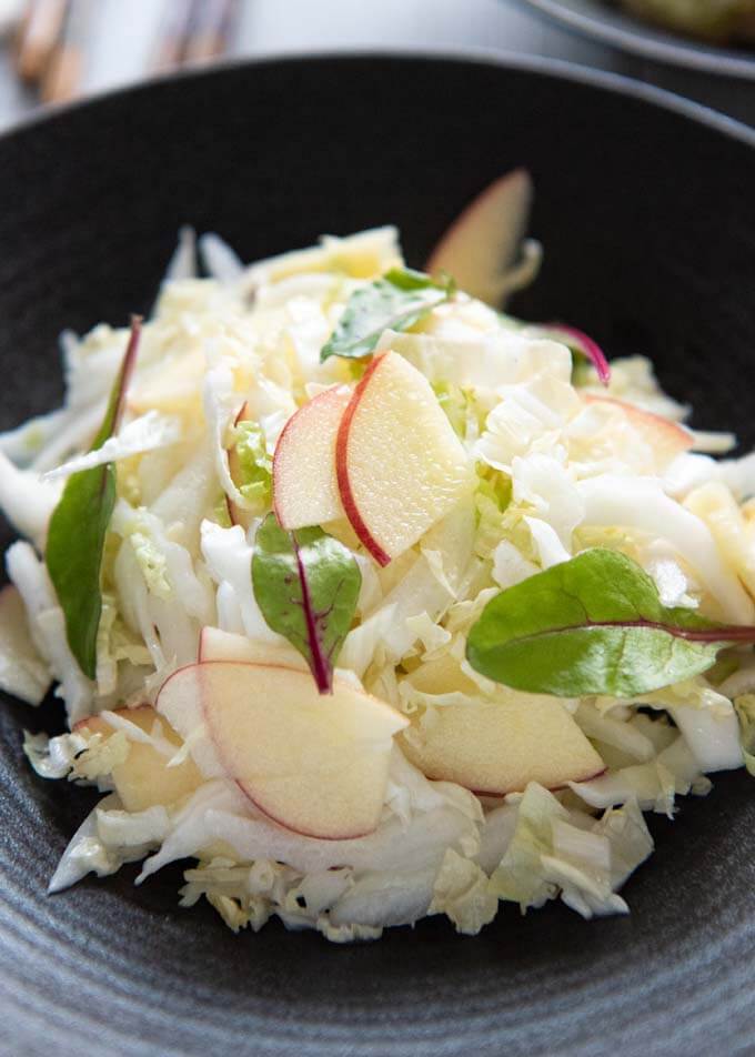 Hero shot of Chinese Cabbage and Apple Salad on a serving bowl.