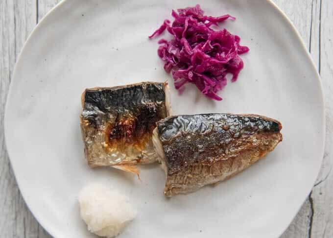 Pickled Red Cabbage is placed next to the grilled mackerel as a garnish.
