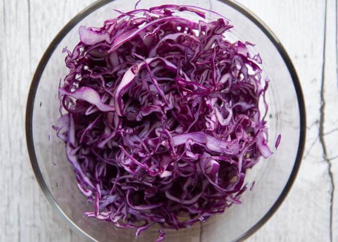 Shredded red cabbage in a bowl.