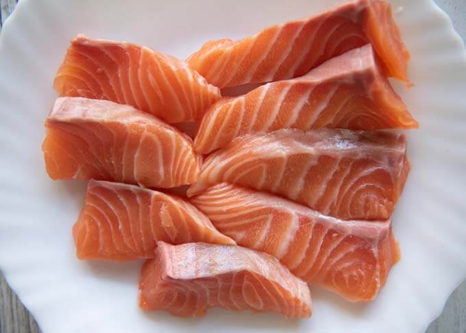Salmon fillets cut to a large bite size.