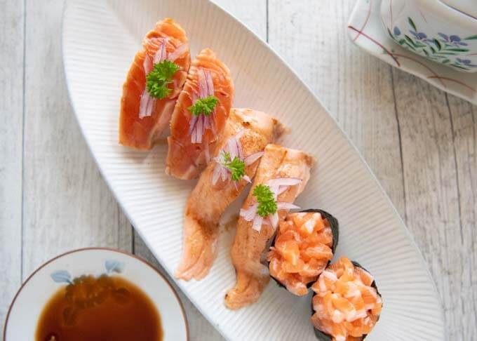 Three different ways of serving salmon sushi - Aburi salmon two wasy + gunkan salmon sushi.