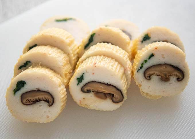 Neatly displayed sliced Steamed Fish Paste with Mushrooms Wrapped in Tofu Skin.