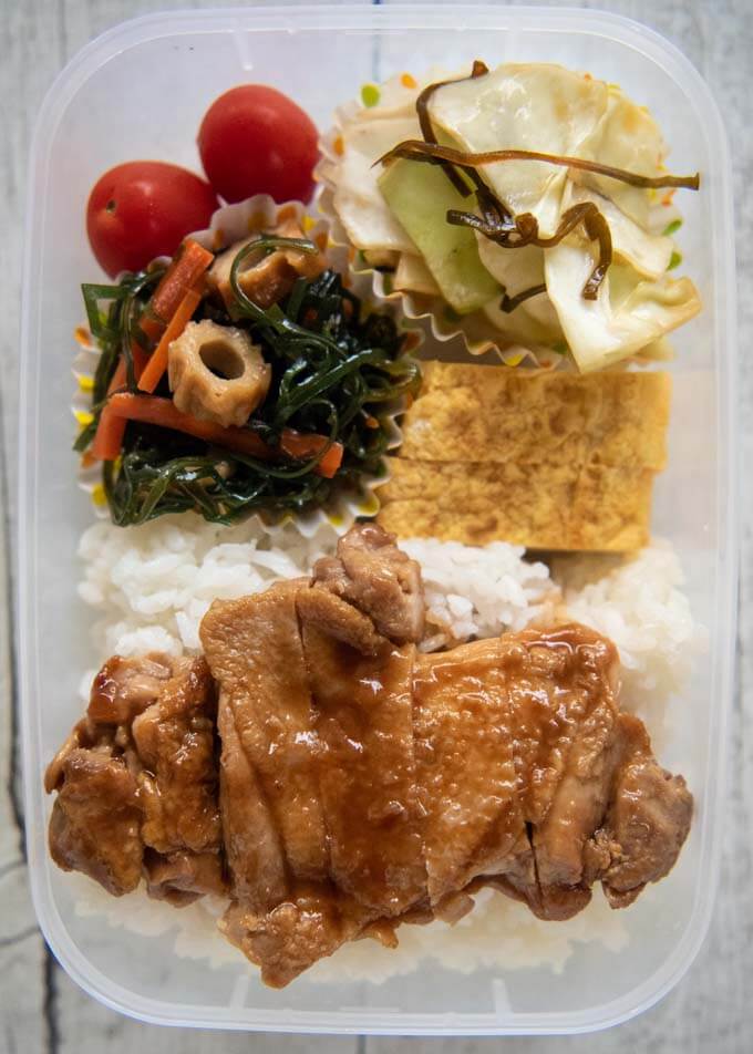 Packing Teriyaki Chicken Bento in a plastic container.