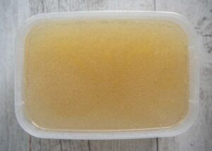 Chinese Chicken Broth in a plastic =k container, ready to freeze.