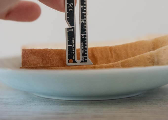 Showing the thickness of the Japanese sandwich bread with a scale.