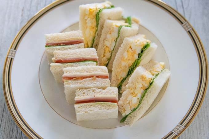 Sandwiches cut into small triangles.